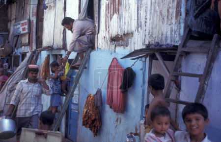 Photo for People and daily life at a village centre of a slum in the city centre of Mumbai in India.  India, Mumbai, March, 1998 - Royalty Free Image