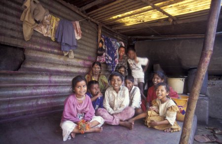 Photo for A Indian Family in a village centre of a slum in the city centre of Mumbai in India.  India, Mumbai, March, 1998 - Royalty Free Image