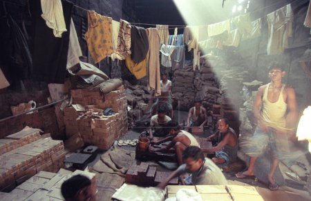 Photo for A stone and brick factory in a fabric house at a village of a slum in the city centre of Mumbai in India.  India, Mumbai, March, 1998 - Royalty Free Image