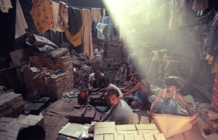 Photo for A stone and brick factory in a fabric house at a village of a slum in the city centre of Mumbai in India.  India, Mumbai, March, 1998 - Royalty Free Image
