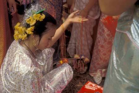 Photo for Traditional dress people at the spring and water festival near the town of Jinghong in Xishuangbanna in the region of the province of Yunnan in China in east asia.  China, Yunnan, April, 1996 - Royalty Free Image