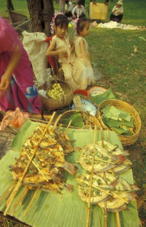 Photo for A traditional food and market at the spring and water festival near the town of Jinghong in Xishuangbanna in the region of the province of Yunnan in China in east asia.  China, Yunnan, April, 1996 - Royalty Free Image