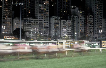 Photo for A horse Race at the Happy Valley racecourse in Central Hongkong in the city of Hongkong in Hongkong.  China, Hongkong, May, 1997 - Royalty Free Image
