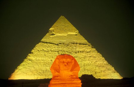 Photo for The pyramids of giza on a light show near the city of Cairo at the capital of Egypt in north africa.  Egypt, Cairo, March, 2000 - Royalty Free Image