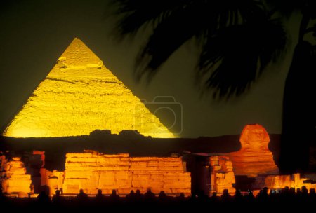 Photo for The pyramids of giza on a light show near the city of Cairo at the capital of Egypt in north africa.  Egypt, Cairo, March, 2000 - Royalty Free Image