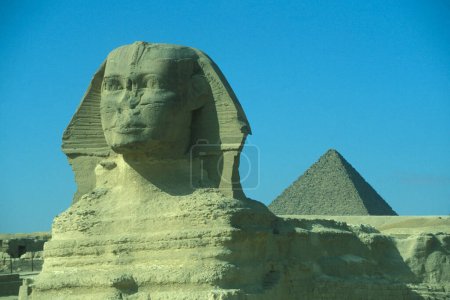 Photo for The monument of Sphinx in front of pyramids of giza near the city of Cairo at the capital of Egypt in north africa.  Egypt, Cairo, March, 2000 - Royalty Free Image