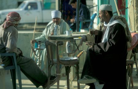 Photo for Men at a traditional Coffee shop at the main Bazaar or Market in the city of Cairo in Egypt in North Africa.  Egypt, Cairo, March, 2000 - Royalty Free Image