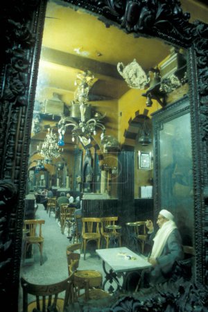 Photo for A traditional Coffee shop at the main Bazaar or Market in the city of Cairo in Egypt in North Africa.  Egypt, Cairo, March, 2000 - Royalty Free Image