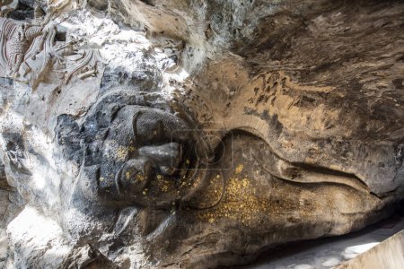 a stone carving reclining Buddha figure in the Fa Tho Cave at Tham Khao Ngu in the Province of Ratchaburi in Thailand,  Thailand, Ratchaburi, November, 15, 2023