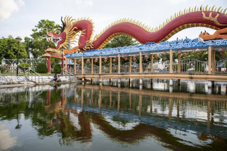 Photo for Ganesha shrine Park with a large Dragon in city centre of Mueang Chonburi City in Province of Chonburi in Thailand.  Thailand, Chonburi, October, 31, 2023 - Royalty Free Image