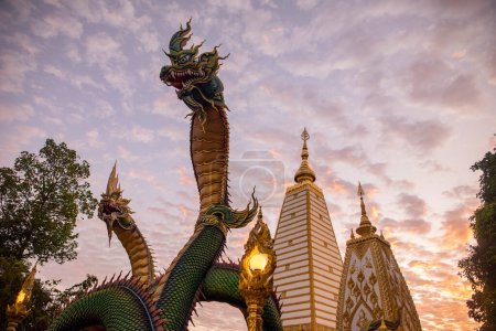 Thailand, Ubon Ratchathani -  November 24, 2023: Rainbow carve serpent surrounding Sri Maha Pho Chedi of Wat Phra That Nong Bua Temple in the city centre of Ubon Ratchathani and Province Ubon Ratchathani in Thailand.