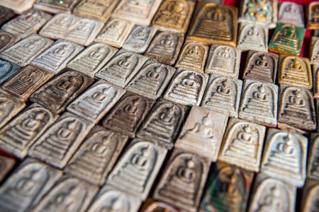 Photo for Thailand, Ubon Ratchathani - November, 25, 2023: Amulets on counter of Thai Amulet market in the city centre of Udon Ratchathani and Province Ubon Ratchathani in Thailand. - Royalty Free Image