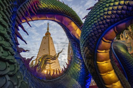 Photo for Thailand, Ubon Ratchathani -  November 24, 2023: Rainbow carve serpent surrounding Sri Maha Pho Chedi of Wat Phra That Nong Bua Temple in the city centre of Ubon Ratchathani and Province Ubon Ratchathani in Thailand. - Royalty Free Image