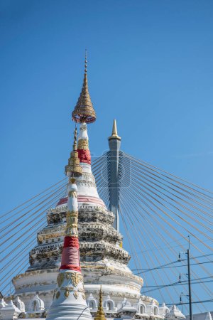 Photo for Wat Songtham with Bhumibol Bridge in Town of Phra Pradaeng near city and Province Samut Prakan in Thailand at December 7, 2023. - Royalty Free Image