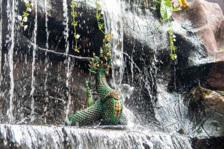 a Nage Figure in the garden of Wat Intharawihan in Thewet in the city of Bangkok in Thailand.  Thailand, Bangkok, December, 9, 2023
