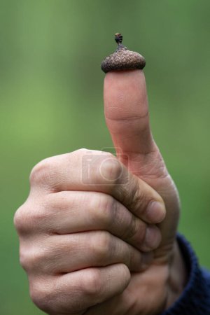 Photo for A hand that shows OK and the thumb has a small thimble - Royalty Free Image
