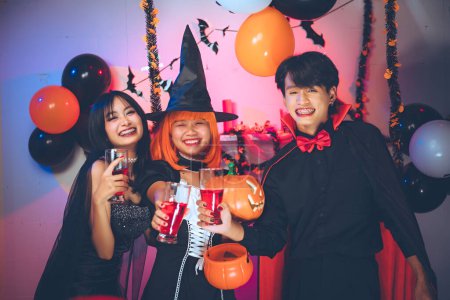 Photo for Halloween party in a bar at friend group. People group do costume fancy sexy, dance, alcohol, drink, happy, smile, on the special holiday of Halloween. Halloween celebration activities. - Royalty Free Image