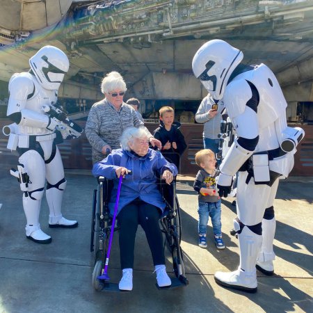 Photo for Orlando, FL USA- February 28, 2020: Storm Troopers talking to a senior woman in the Star Wars area  in Hollywood Studios Walt Disney World in Orlando, Florida. - Royalty Free Image