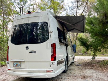 Foto de Fort White, FL USA - 2 de marzo de 2023: Una furgoneta camper en un camping cerca de Fort White, Florida en un hermoso día soleado. - Imagen libre de derechos