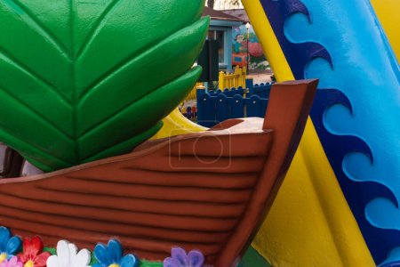Colorful playground on yard in the park. Plastic decorative ornaments of the childrens area, close-up.