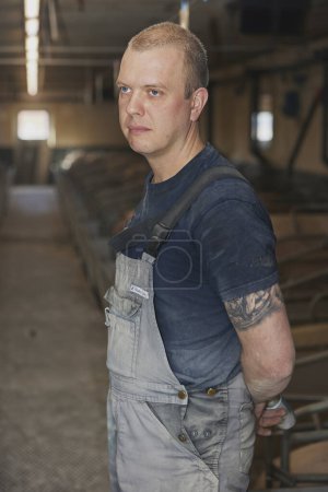 Téléchargez les photos : Ringkobing, Danemark, 28 avril 2024 : Travailleur dans une ferme porcine moderne. - en image libre de droit