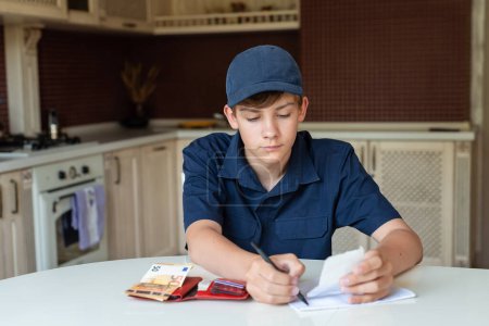 Photo for Teen boy is counting checking the pocket money in his wallet, home background. Freelancer, work for students, first salary. Money saving, self finance, planning. - Royalty Free Image