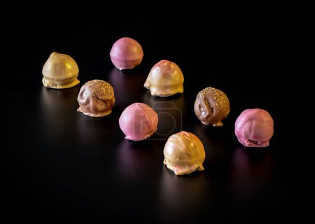 Photo for Colorful chocolate truffle (pralines) on black backgound - Royalty Free Image