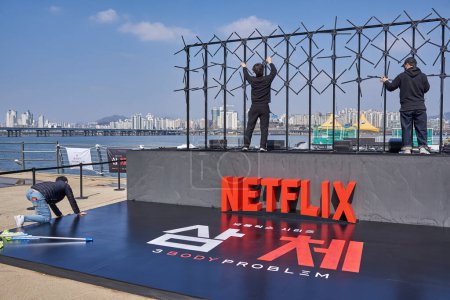 Photo for Workers set up promotional stand for 3 Body Problem Netflix science fiction television series in Yeouido Hangang Park in Seoul, South Korea on 23 March 2024 - Royalty Free Image