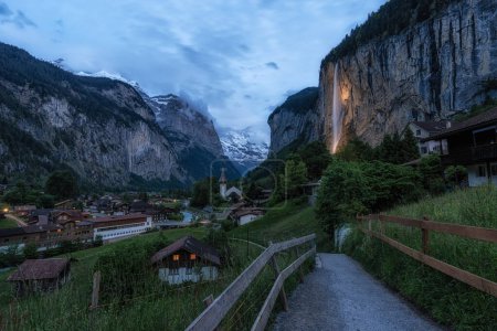 The view of Lauterbrunnen and village town and Staubbach waterfall taken in the morning. Famous tourist attraction in Switzerland