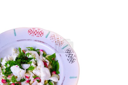 Photo for Vegetable salad from the garden. Watercress salad and white and red radish cut in a plate with colorful ornament, white cheese and sour cream, isolate, fresh, natural, top view - Royalty Free Image