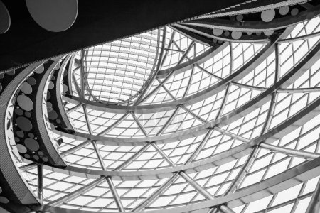 Photo for Astana, Kazakhstan - 10.22.2022: Futuristic Interior. Glass roof with solar panels and levels floors of round Sphere modern building, view from below. Glass roof and walls. Black and white photo. - Royalty Free Image
