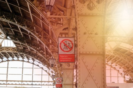 Photo for St. Petersburg, Russia - 07.11.2022: Interior of the Vitebsk railway station, sunflare. Red vertical Warning sign, translation: Do not leap from platform. - Royalty Free Image