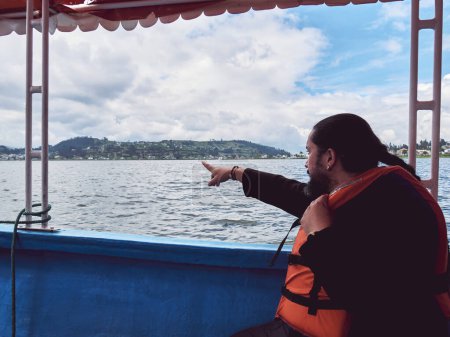 Photo for Enjoying a Peaceful Day on the Lake: Man in a Life Vest, cloudy - Royalty Free Image