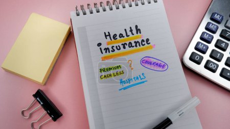 Concept of health insurance written on note pad while doing plan for insurance.