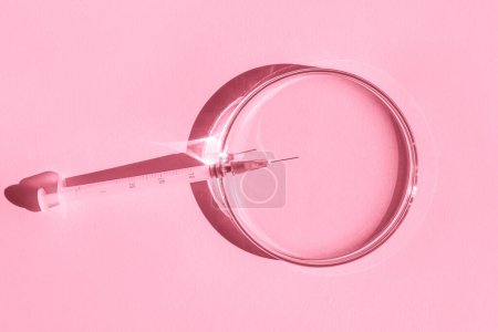 Petri dishes. small syringe. On a pink background.
