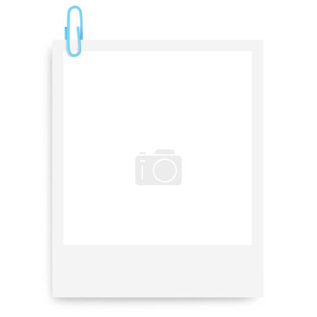 marco de fotos Polaroid blanco con un clip de papel azul sobre un fondo en blanco.