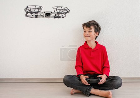 Photo for Cute boy operating the dron or quadcopter by remote control on white background. - Royalty Free Image