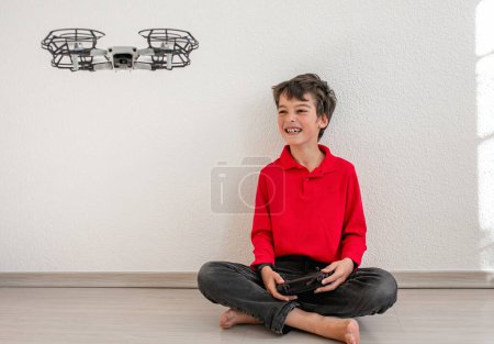 Téléchargez les photos : Cute boy operating the dron or quadcopter by remote control on white background. - en image libre de droit