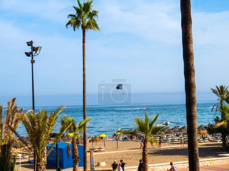 Photo for Hang Glider over Beach and  the promenade in Fuengirola on the Costa Del Sol Spain - Royalty Free Image