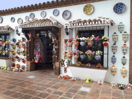 Photo for Mijas one of the most beautiful `white` villages of the Southern Spain area called Andalucia. It is in the mountains above the coast.The village is built on the side of the mountain and is very picturesque. This a pottery Shop in the village - Royalty Free Image