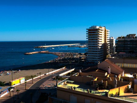 Photo for The marina and beach at Fuengirola as seen from a hotel Balcony 9 floors up as the sun was setting behind the mountains in the west ofSpain - Royalty Free Image