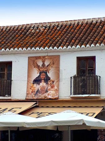 Photo for Old Religious Mural on the wall of a cafe opposite the church in Mijas, one of the mountain villages above the Costa Del Sol in Spain - Royalty Free Image
