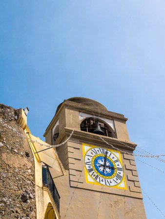 Photo for The clock tower in the town of Capri which has been a resort island since Roman times . It is situated in the Gulf of Naples and is covered with architecture from all the successive generations - Royalty Free Image