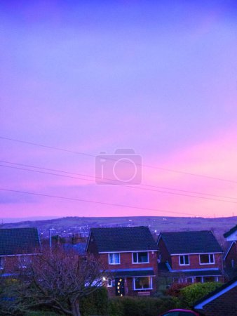Photo for Sunset over Lancashire England. This display was glorious just for a few moments over the rooftops of Burnley.. Then the sky became dark and the sun set behind the hills - Royalty Free Image