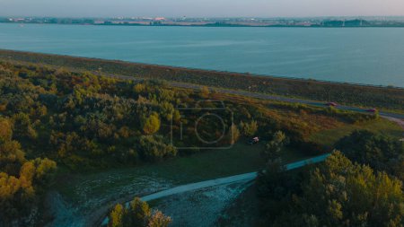 Photo for Aerial view over Danube river near Bratislava, Slovakia. The Photography was shoot from a drone at a higher altitude above the river in the morning at sunrise. - Royalty Free Image
