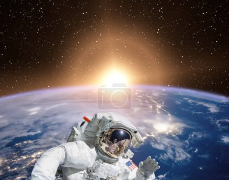 Photo for Planet earth and fascinating sunrise. Astronaut on backdrop. The elements of this image furnished by NASA - Royalty Free Image