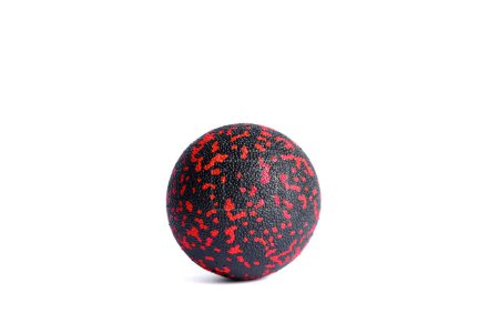 Massage black ball with red spots for trigger points isolated on a white background. Concept of myofascial release.