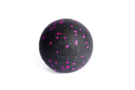 Massage black ball with pink spots for trigger points isolated on a white background. Concept of myofascial release.