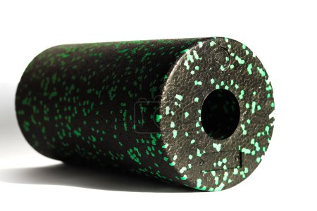 Photo for A black green massage foam roller isolated on a white background. Close-up. Foam rolling is a self myofascial release technique. Concept of fitness equipment. - Royalty Free Image