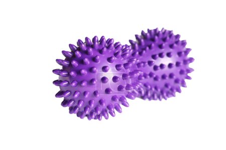 Purple double or peanut spikey ball massager for yoga pilates or stretching and fascia pain. Sports equipment for fitness isolated on a white background. Concept of sports massage.